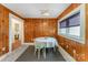 Bright dining area with wood paneled walls and a view into an adjacent room at 230 Dunham Ave, Salisbury, NC 28146