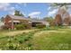 A charming brick home with meticulous landscaping featuring vibrant yellow daffodils at 230 Dunham Ave, Salisbury, NC 28146