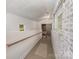 Well lit hallway with white brick accent wall, with access to the garage at 230 Dunham Ave, Salisbury, NC 28146