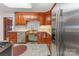 Well-lit kitchen featuring wood cabinetry, stainless steel appliances, and a stainless steel sink at 230 Dunham Ave, Salisbury, NC 28146