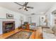 Comfortable living room with hardwood floors, a ceiling fan, and a classic brick fireplace at 230 Dunham Ave, Salisbury, NC 28146