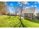 Expansive backyard featuring a screened-in porch, mature trees, a fire pit, and plenty of open space at 2966 Huckleberry Hill Dr, Fort Mill, SC 29715