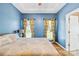 Serene bedroom with blue walls, tray ceiling, and natural light from two windows at 2966 Huckleberry Hill Dr, Fort Mill, SC 29715