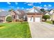 Charming brick home featuring an attached two-car garage and a meticulously manicured front lawn at 2966 Huckleberry Hill Dr, Fort Mill, SC 29715