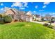 Beautifully landscaped front yard showcasing a well-maintained lawn and mature trees in a residential neighborhood at 2966 Huckleberry Hill Dr, Fort Mill, SC 29715