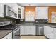 Bright kitchen with stainless steel appliances, white cabinets, and tiled backsplash at 2966 Huckleberry Hill Dr, Fort Mill, SC 29715