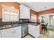 Well-lit kitchen featuring stainless steel dishwasher, a double sink, and dining area access at 2966 Huckleberry Hill Dr, Fort Mill, SC 29715