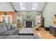 Cozy living room featuring a fireplace, skylights, and comfortable seating for relaxing or entertaining guests at 2966 Huckleberry Hill Dr, Fort Mill, SC 29715