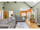 Inviting living room featuring an open layout with a large gray couch and wood flooring at 2966 Huckleberry Hill Dr, Fort Mill, SC 29715