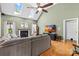 Inviting living room features a fireplace, hardwood floors, and plenty of natural light from the skylights at 2966 Huckleberry Hill Dr, Fort Mill, SC 29715