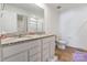 This bathroom features a double sink vanity with granite countertops and a walk-in shower at 3077 Light Ridge Sw Ct, Concord, NC 28027