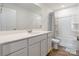 Well-lit bathroom featuring a vanity with ample storage, a large mirror, and a shower-tub combination at 3077 Light Ridge Sw Ct, Concord, NC 28027