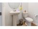 This half bath features a pedestal sink, modern toilet, and a round mirror at 3077 Light Ridge Sw Ct, Concord, NC 28027