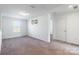 A vacant bedroom with neutral carpet and a window providing natural light at 3077 Light Ridge Sw Ct, Concord, NC 28027