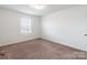 Comfortable bedroom with a window for natural light, neutral walls, and plush carpeting at 3077 Light Ridge Sw Ct, Concord, NC 28027