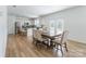 Open-concept kitchen and dining area with stainless steel appliances and hardwood floors at 3077 Light Ridge Sw Ct, Concord, NC 28027