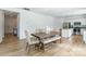 Bright dining area featuring hardwood floors, natural light, and a view of the modern kitchen at 3077 Light Ridge Sw Ct, Concord, NC 28027