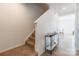 Light-filled foyer with hardwood floors, staircase, and stylish console table at 3077 Light Ridge Sw Ct, Concord, NC 28027