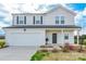 Charming two-story home boasts an attached garage, tidy landscaping, and welcoming entrance at 3077 Light Ridge Sw Ct, Concord, NC 28027