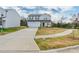 Two-story home featuring neutral siding, attached garage, long driveway, and well-maintained lawn at 3077 Light Ridge Sw Ct, Concord, NC 28027