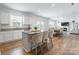 Open kitchen and dining area with granite counters, an island with seating, and stainless appliances at 3077 Light Ridge Sw Ct, Concord, NC 28027