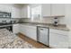 Modern kitchen with stainless steel appliances, granite countertops, and white cabinets at 3077 Light Ridge Sw Ct, Concord, NC 28027