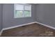 Bedroom showcasing durable floors, neutral walls, and natural light filtering through the window at 326 Mountain View St, Gastonia, NC 28052