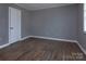 Bedroom featuring laminate floors, neutral gray paint, and a clean, streamlined space at 326 Mountain View St, Gastonia, NC 28052