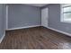 Bedroom featuring laminate floors, a window, neutral paint, and a practical layout at 326 Mountain View St, Gastonia, NC 28052