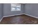 Neutral bedroom showcasing hardwood floors, a window, and fresh paint at 326 Mountain View St, Gastonia, NC 28052