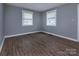 Bright bedroom with hardwood floors and two windows at 326 Mountain View St, Gastonia, NC 28052