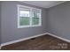 A bright bedroom with hardwood floors and a window with blinds at 326 Mountain View St, Gastonia, NC 28052