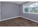 Bright bedroom with hardwood floors and a large window at 326 Mountain View St, Gastonia, NC 28052