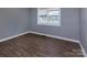 Neutral bedroom showcasing hardwood floors, a window, and fresh paint at 326 Mountain View St, Gastonia, NC 28052