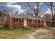 Brick duplex with tidy lawn, showing black shutters and twin entryways for separate living at 326 Mountain View St, Gastonia, NC 28052