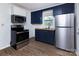 Modern kitchen with stainless steel appliances and newly installed hardwood floors at 326 Mountain View St, Gastonia, NC 28052