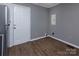 An empty room features modern flooring and a white door at 326 Mountain View St, Gastonia, NC 28052