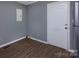 An empty room features modern flooring and a white door at 326 Mountain View St, Gastonia, NC 28052