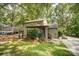 View of the home's exterior, complemented by a screened porch, well-maintained lawn, and a driveway leading to the garage at 4124 Woodfox Dr, Charlotte, NC 28277