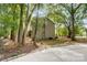 The home features verdant surroundings, mature trees, and a well-maintained driveway leading to a peaceful residential setting at 4124 Woodfox Dr, Charlotte, NC 28277