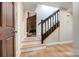 Hallway with hardwood floors, stairs, and view of a fireplace at 4124 Woodfox Dr, Charlotte, NC 28277