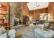 Living room with stone fireplace, wood paneling, and a ceiling fan for a rustic feel at 4124 Woodfox Dr, Charlotte, NC 28277