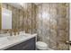 Stylish powder room with unique wallpaper, modern vanity, and gold fixtures at 4124 Woodfox Dr, Charlotte, NC 28277