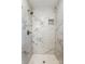 Modern shower featuring elegant marble-style tile and sleek fixtures at 4124 Woodfox Dr, Charlotte, NC 28277