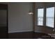 Cozy dining area with hardwood floors, large windows, and a stylish hanging light fixture at 4892 Horseback Ln, Harrisburg, NC 28075