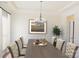 Elegant dining room with a large wooden table, decorative chandelier, and wainscoting at 4892 Horseback Ln, Harrisburg, NC 28075