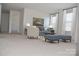 Cozy living room with soft seating, a neutral color palette, and bright natural light at 4892 Horseback Ln, Harrisburg, NC 28075