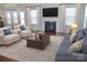 Bright living room with a fireplace, plush seating, and large windows for ample natural light at 4892 Horseback Ln, Harrisburg, NC 28075