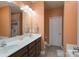 Bathroom featuring double sinks, vanity with dark cabinets, and a separated shower stall at 623 Hicklin Dr, Rock Hill, SC 29732