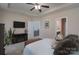 Bedroom featuring a flat screen television, tray ceiling, and access to the bathroom at 623 Hicklin Dr, Rock Hill, SC 29732